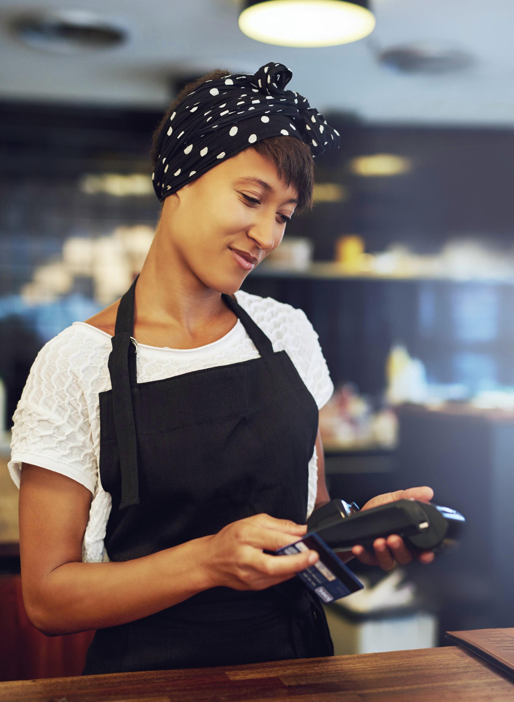 Small business owner holding a card reader.