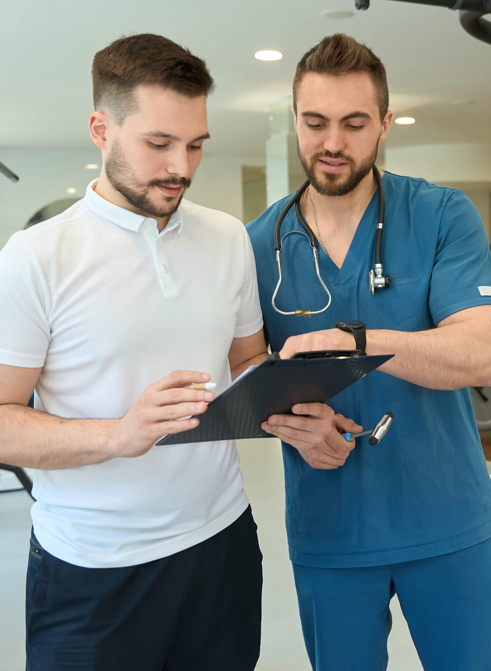 Rehabilitation specialist speaking with a doctor. 
